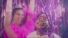 Two women smiling mid dance