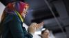 Woman clapping in head scarf