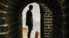 Man standing in archway at the Great Wall of China 