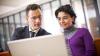 Man and woman working on laptop