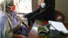 Sumaya Akter Tithi using a stethoscope on another woman 