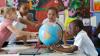 Schoolchildren playing with a globe