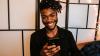 Man holding a mobile phone and smiling