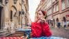Image of a young Polish woman sitting at a table on the street