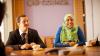 Man and lady sat at a meeting table