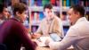 Men sitting around table in a library
