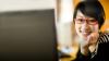 A woman with glasses smiling
