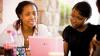 Two women looking at a laptop