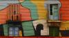 colourful painted wall with two shutter doors and balconies
