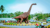 Life size replica dinosaur cast in the Lindi Region, Tanzania, standing on a roundabout.