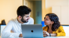 Man and woman looking at laptop