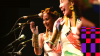 Two dancers smiling in front of microphones
