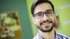 Young man wearing glasses smiling at the camera