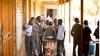 A group of South Africa students chat together on the school verandah
