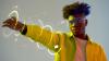 Man holding out his arm, which is surrounded by circles of dotted yellow lights.