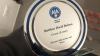 A circular silver coloured award with a blue circle decoration, awarded to Matthew David Robson.