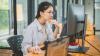 Woman working on a desktop computer.
