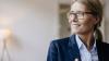 Woman, middle age, glasses, smiling.