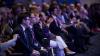 Individuals sitting in the audience.