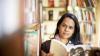 Woman in library holding a book 