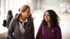 Two women students chat together in the corridor