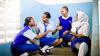 Four young Kenya students sit together chatting