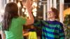 Two young people high-fiving