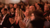 Group of people applauding at a conference event.